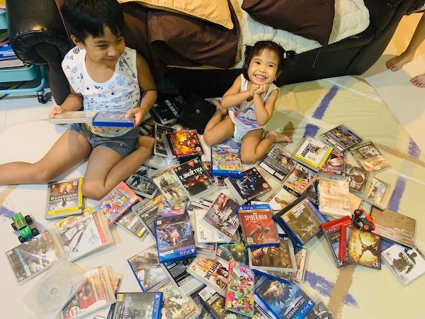 Miggy and Ellie enjoying their daddy's game collection